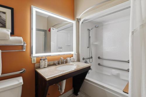 a bathroom with a sink and a shower and a tub at Holiday Inn Hotel & Suites Slidell by IHG in Slidell