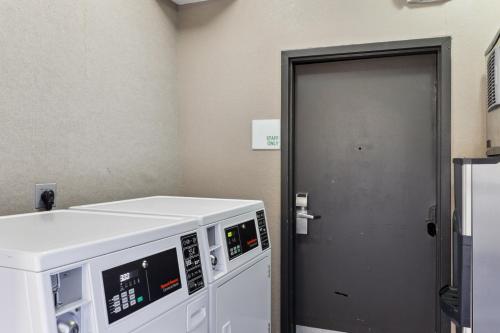 a door to a room with a machine next to it at Holiday Inn Hotel & Suites Slidell by IHG in Slidell