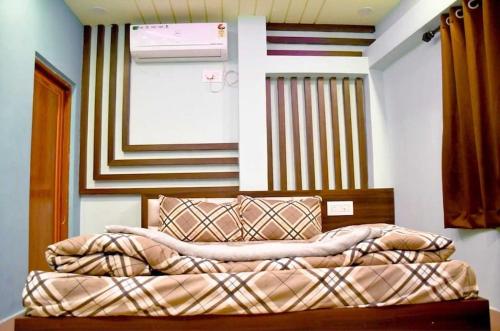 a bedroom with a bed in a room with avertisement at Super OYO The Orchid Residency in Kolkata