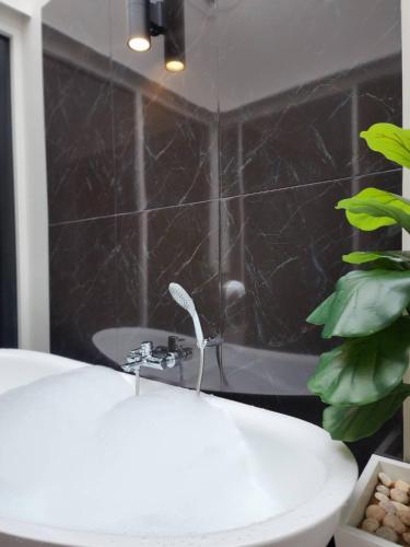 a bathroom with a white sink and a bath tub at KVILLA in Ban Khlong Bang Chak