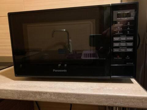 a microwave sitting on a counter in a kitchen at Private House , in the middle of the city, in 10 min. To Fabrika in Tbilisi City