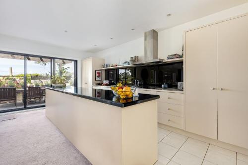 a kitchen with a counter with a bowl of fruit on it at Secluded Luxury on Tower Hill in Somers