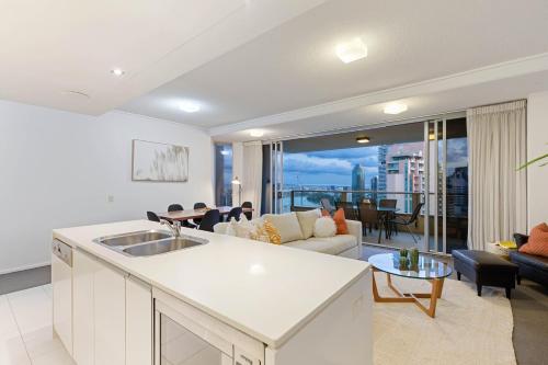 a kitchen and living room with a view of the city at AAB Apartments Skyline in Brisbane