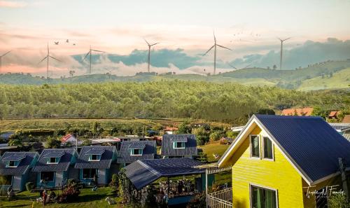 a row of houses with windmills in the background at โซพราว เขาค้อ So Proud Khaokho in Khao Kho