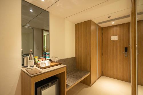 a bathroom with a sink and a mirror at Golden Tulip Bhopal in Bhopal