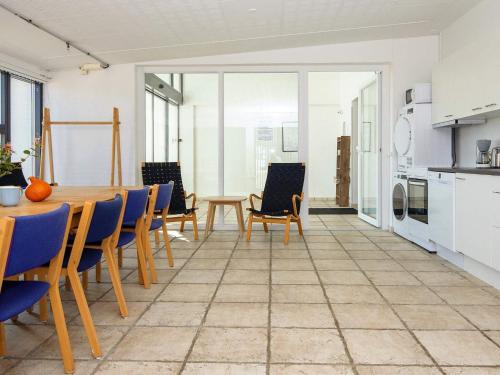 a kitchen and dining room with a table and chairs at Apartment in Holiday park- shared kitchen in Ulfborg