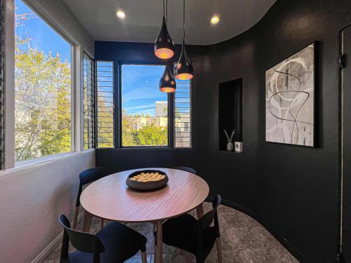 a dining room with a table and chairs and a window at Stylish Residence in Los Angeles - OL-WH in Los Angeles