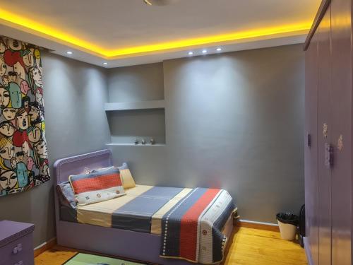 a small bedroom with a bed in a room at Luxury Apartment in Port Said