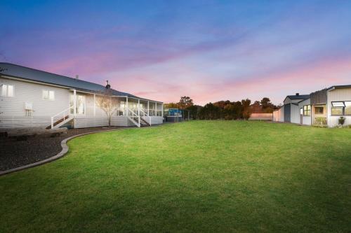 a large yard in front of a house at Kulang Retreat in charming Broke with Large Swim Spa and games room suits up to 14 guests in Broke