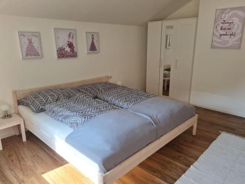 a large bed in a bedroom with two tables at StayEasy Apartments Ramingtal #1 