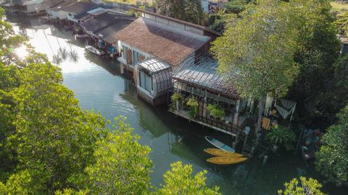 an aerial view of a river with houses and a boat at Escape Life Koh Kood in Ko Kood