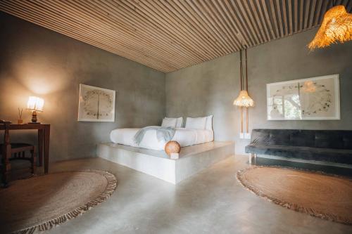 a bedroom with a bed and a couch in it at FARMHOUSE58 in Krugersdorp