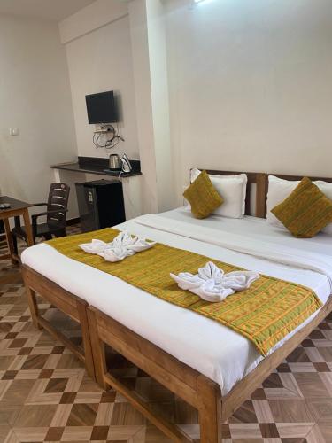 a bedroom with two beds with towels on them at Baga Beach Prime in Baga
