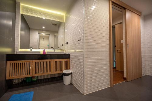 a bathroom with a sink and a mirror at Patong Poshtel in Patong Beach