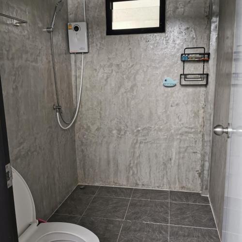 a bathroom with a shower and a toilet at โซพราว เขาค้อ So Proud Khaokho in Khao Kho