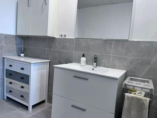 a kitchen with a white sink and a cabinet at Finca Aideta- casa confortable con barbacoa 