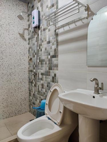 a bathroom with a toilet and a sink at El Juliana Hotel in Vigan