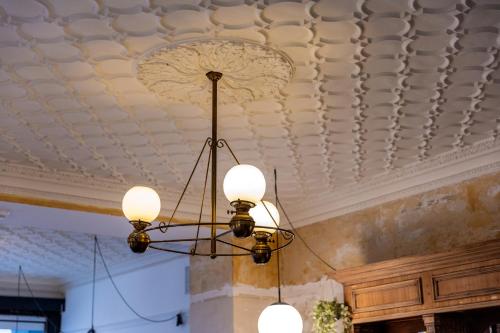 a chandelier hanging from a ceiling in a room at Hotel Bristol in Luxembourg