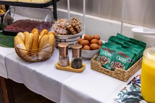 a table with bread eggs and other foods on it at Hotel Bristol in Luxembourg