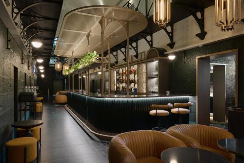 a restaurant with a bar with chairs and tables at The Interlude in Melbourne