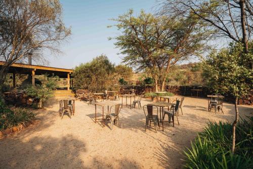 a group of tables and chairs in the sand at FARMHOUSE58 in Krugersdorp