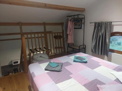a bedroom with a large bed with two towels on it at Loft avec SPA privatisé in Sainte-Foy-Saint-Sulpice
