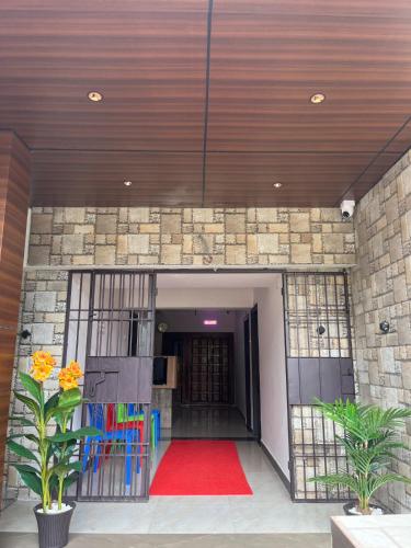 a hallway with a red carpet in front of a building at SAN BEACH RESIDENCY in kāraikāl