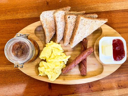 a plate of breakfast food with sausage and eggs at Bathala Resort in Panglao