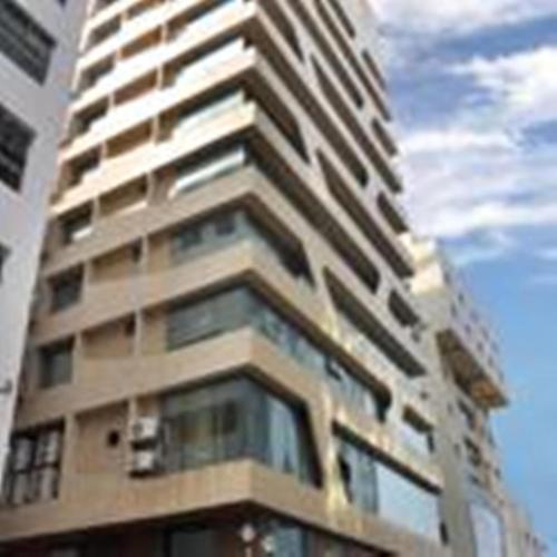 a tall building with windows on the side of it at Hotel Senses in Kolkata