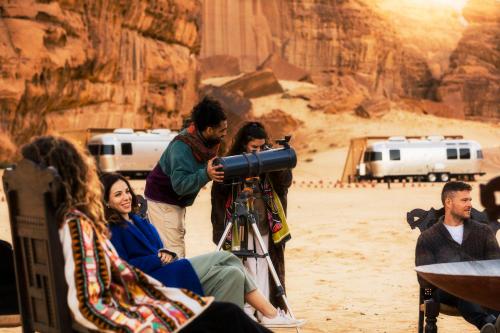 a man taking a picture of a group of people at Caravan AlUla by Our Habitas in AlUla