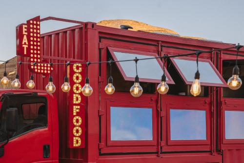 a red food truck with lights on the side of it at Caravan AlUla by Our Habitas in AlUla