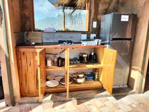 a kitchen with a counter and a refrigerator at Bela Flor Beach Front Apartments in Inhambane