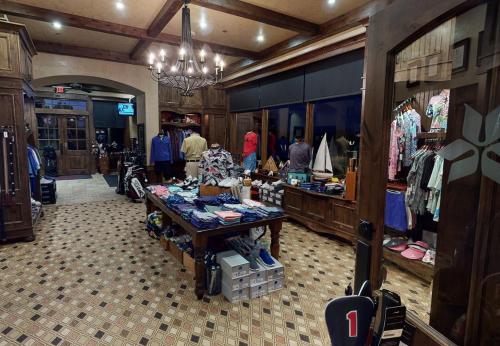 a clothing store with people walking around a store at Shangri-La Resort in Monkey Island