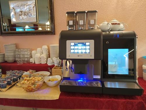 a coffee machine sitting on top of a table at Hotel Adele in Livigno