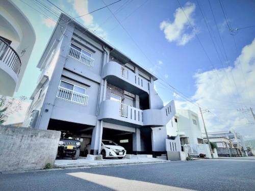 a white building with a car parked in front of it at casagrande in Koniya