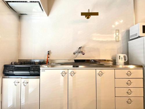 a kitchen with a sink and a stove at casagrande in Koniya