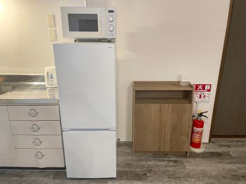 a white refrigerator with a microwave on top of it at casagrande in Koniya