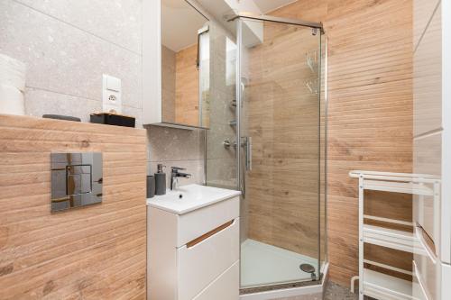 a bathroom with a shower and a white sink at Kasprowicza 15 by Homeprime in Warsaw