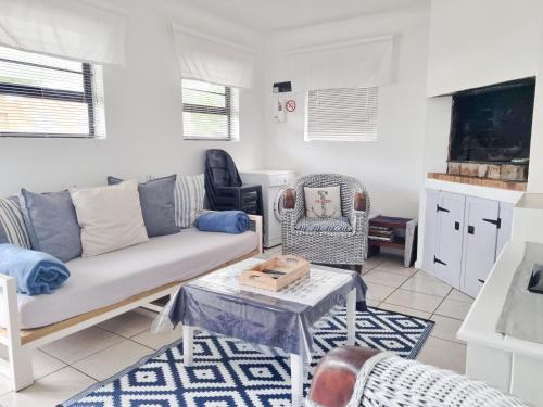 a living room with a couch and a table at Pearly Gate in Pearly Beach