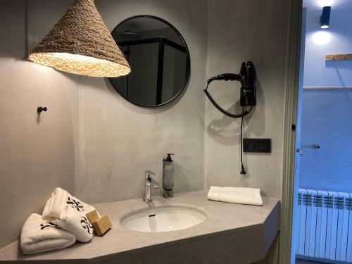 a bathroom with a sink and a mirror at Calendula Hotel & Apartaments in Sant Feliu de Guixols