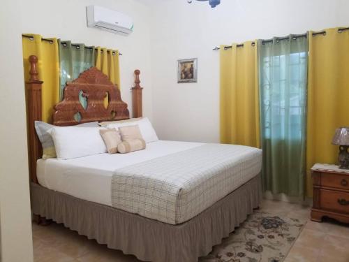 a bedroom with a bed with yellow and green curtains at The Sweet Spot king Bed in Florence Hall