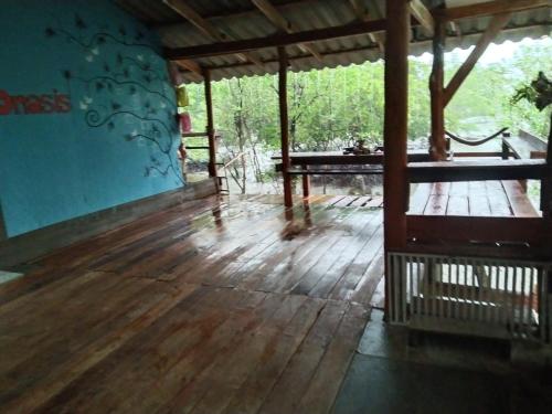 a porch with a wooden floor and a wooden table at บ้านปู in Ko Yao Noi