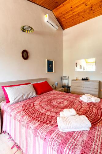 a bedroom with a large bed with two towels on it at La Caletta di Afrodite in Calabernardo