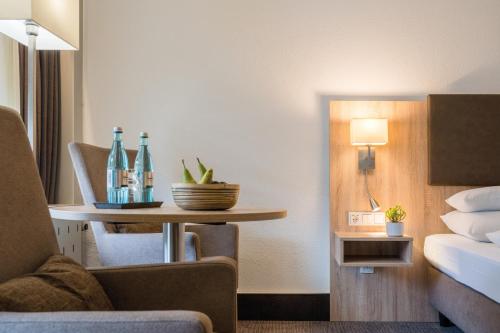 a hotel room with a table with bottles on it at Hotel Frankenland in Bad Kissingen