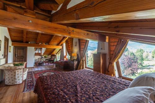 ein Schlafzimmer mit einem Bett und einem großen Fenster in der Unterkunft L'Atelier du Temps - LE SECRET in Aosta