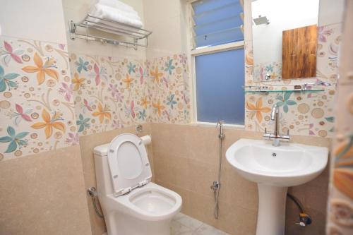 a bathroom with a toilet and a sink at Hotel Arati Pvt. Ltd. in Kathmandu