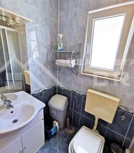 a bathroom with a sink and a toilet and a mirror at Panoramablick in Trogir
