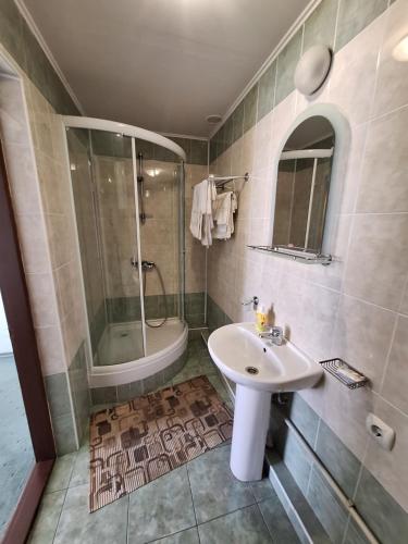 a bathroom with a sink and a shower at Барселона in Odesa