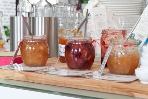 a group of jars of honey on a shelf at Suitehotel Pincoffs in Rotterdam