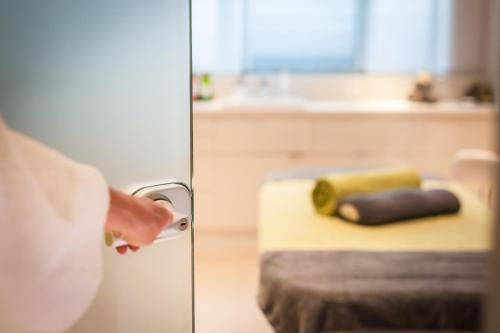 a person is opening the door to a room at Hotel Frankenland in Bad Kissingen